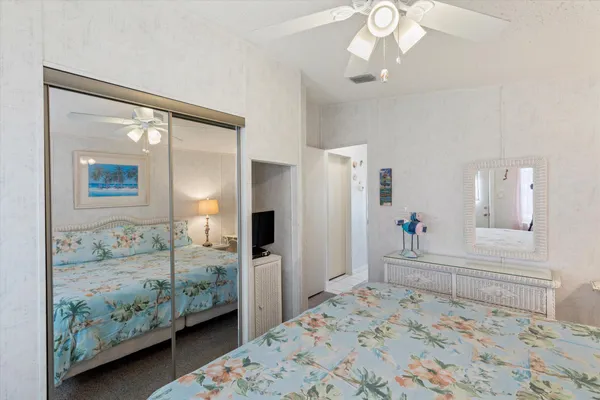 a bedroom with a large bed and a chandelier