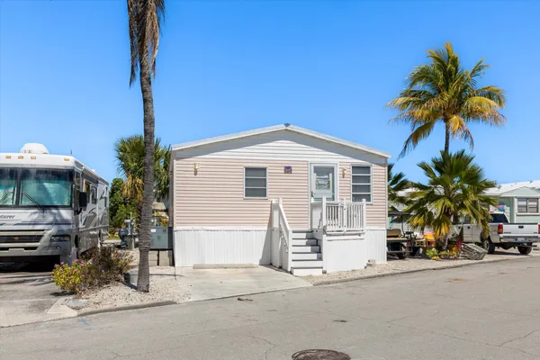 a vase of flowers sitting on a floor