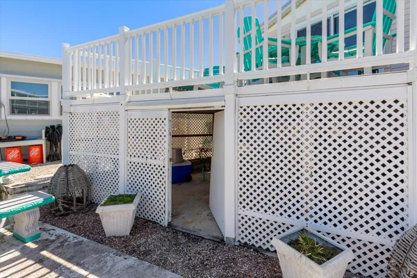 a view of a house with a yard and potted plants