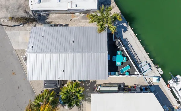 an aerial view of residential houses with outdoor space and lake view