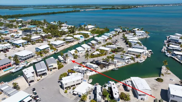 an aerial view of a house with a garden swimming pool outdoor seating and yard