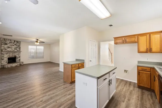 an open kitchen with sink and cabinets