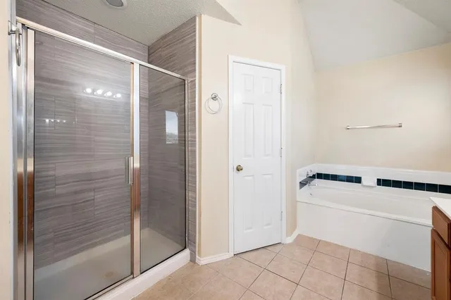 a bathroom with a bathtub and shower