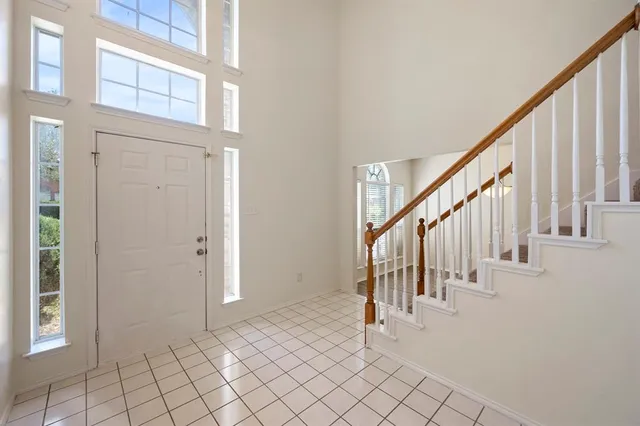 a view of entryway with wooden floor and stairs