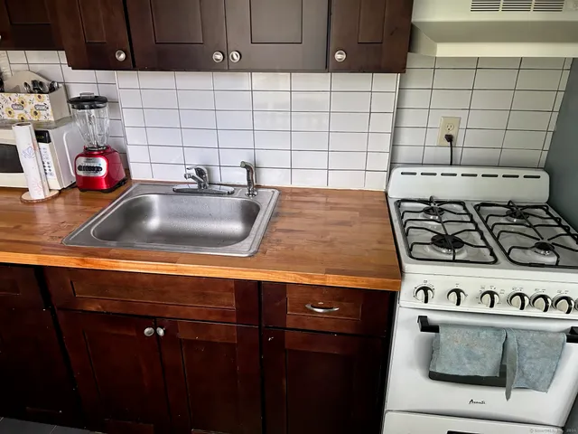 a kitchen with a stove and cabinets