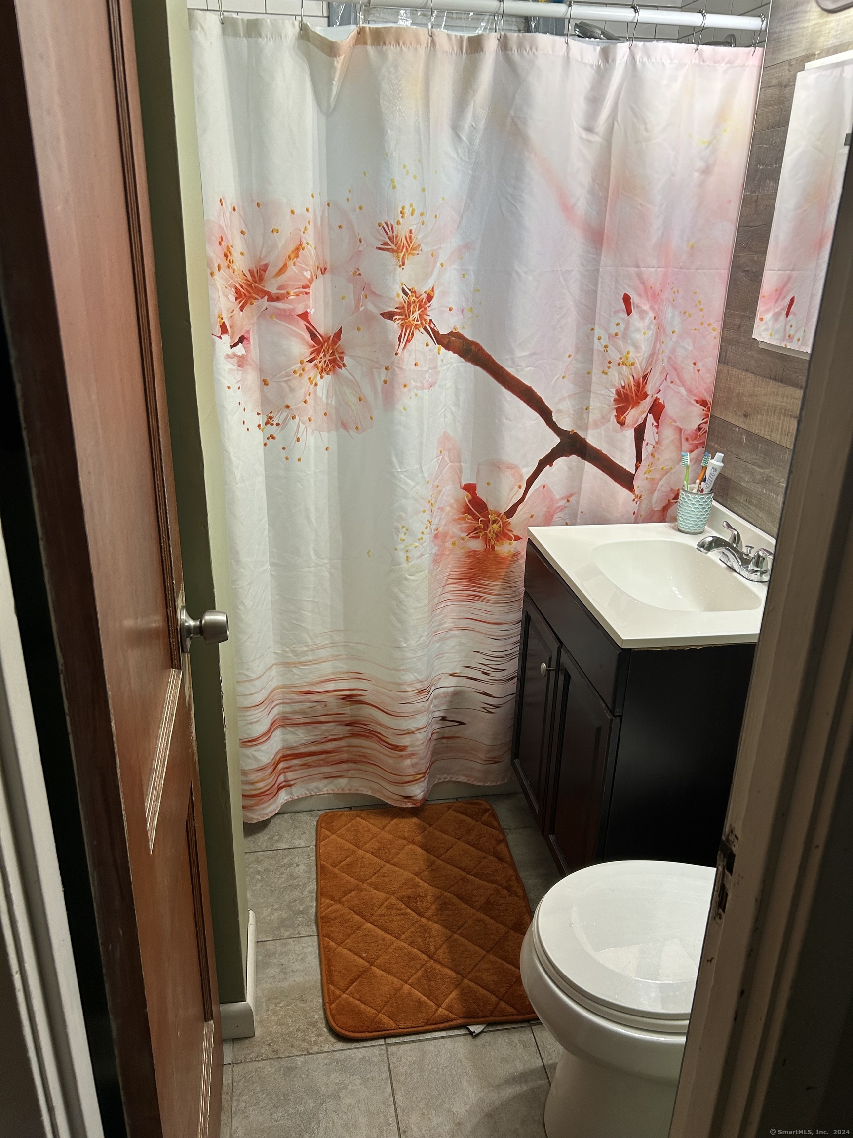 260 Success Avenue, Unit 21 Bridgeport, CT 06610 - Photo 7 of 15 a bathroom with a sink a toilet and shower curtain