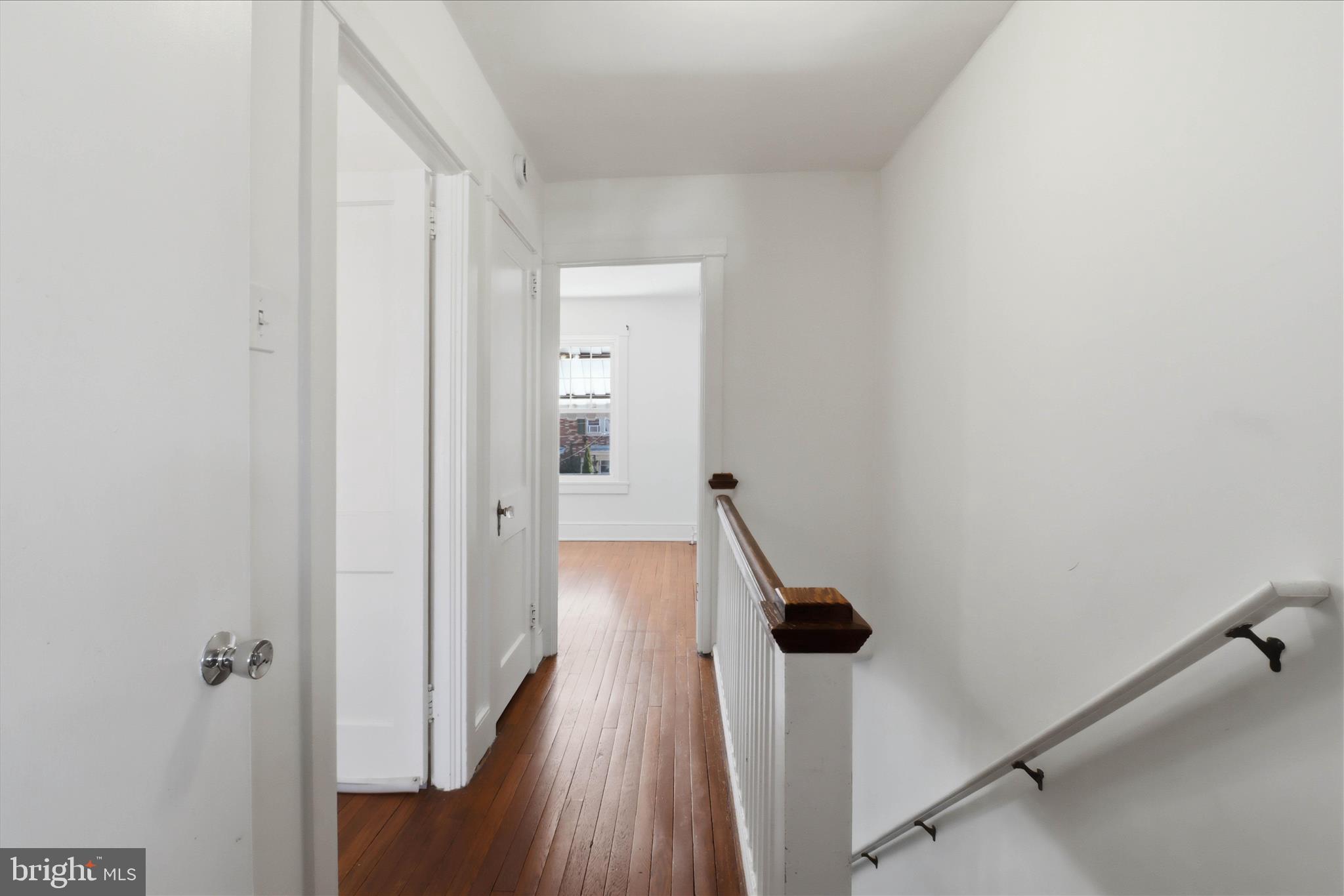 521 Hamilton Street Lancaster, PA 17602 - Photo 18 of 44 a view of a hallway with a wooden floor and staircase