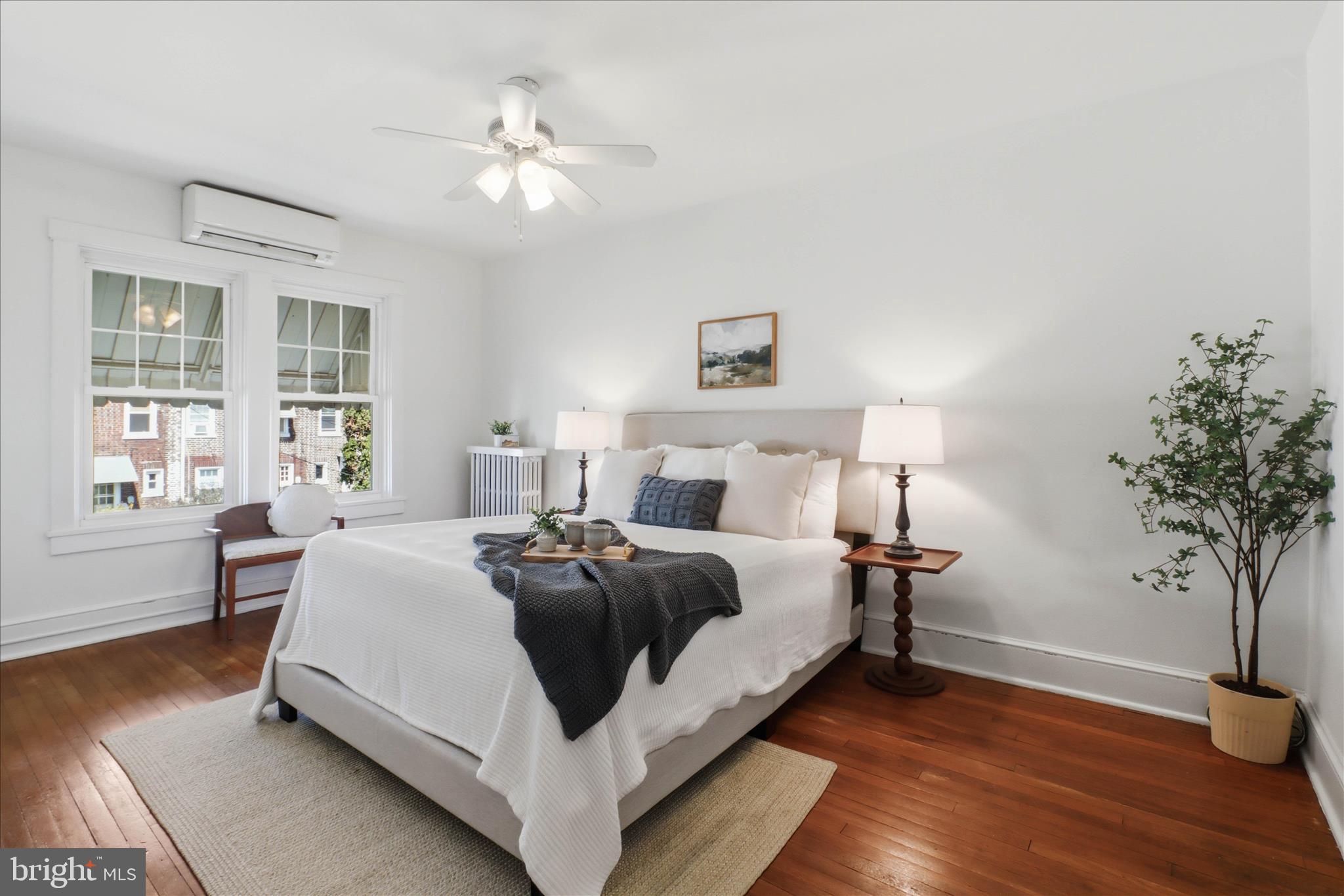 521 Hamilton Street Lancaster, PA 17602 - Photo 19 of 44 a bedroom with a bed and a potted plant with wooden floor