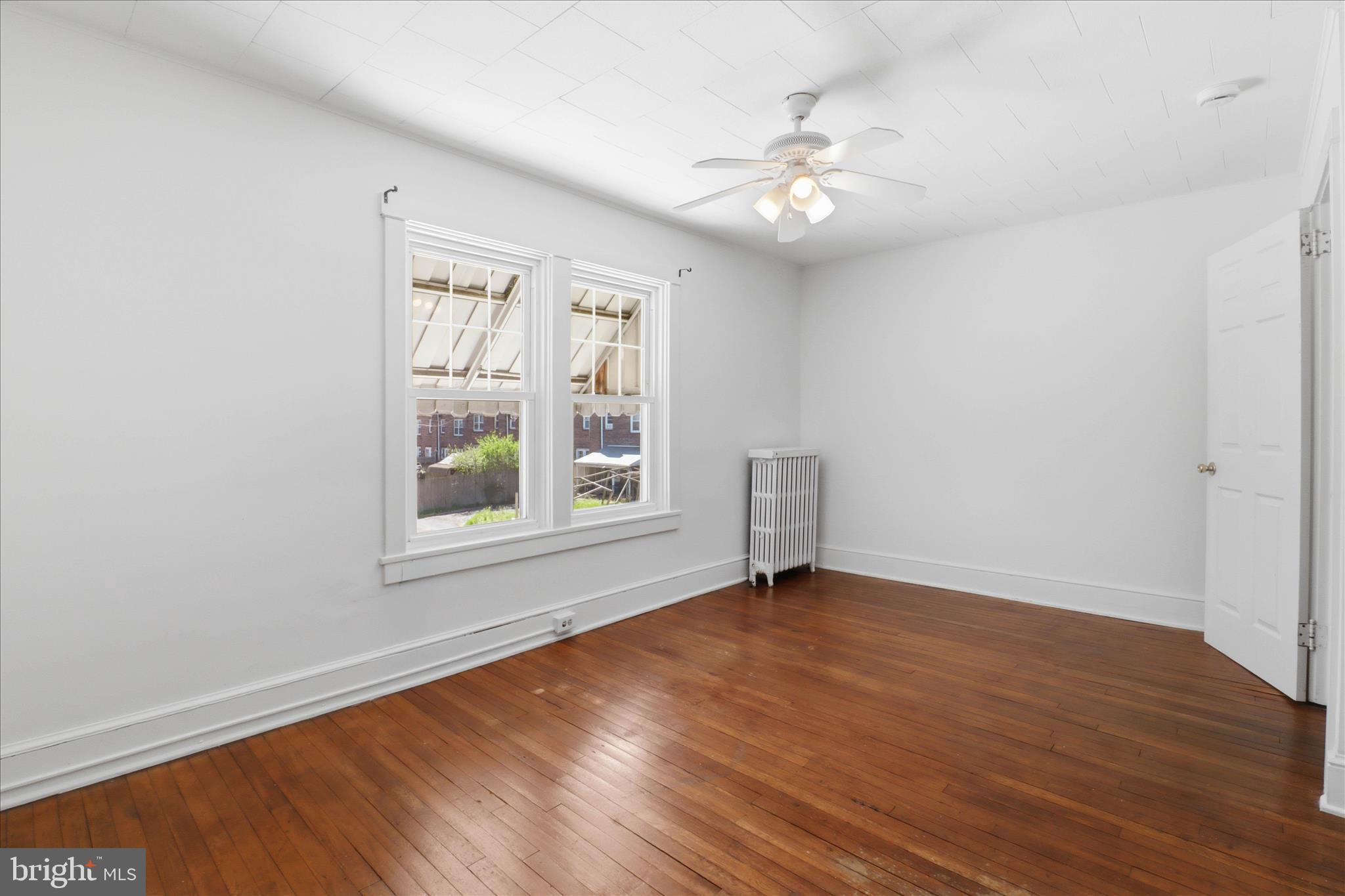 521 Hamilton Street Lancaster, PA 17602 - Photo 26 of 44 a view of an empty room with wooden floor and a window