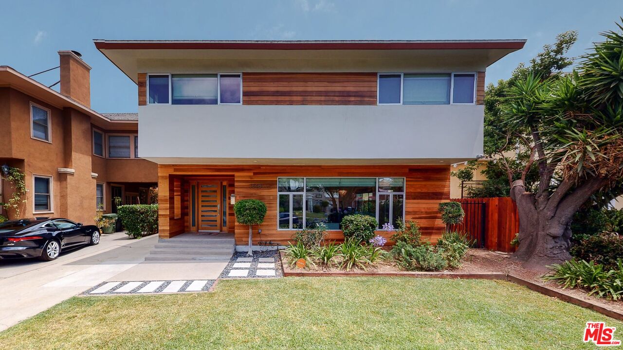 1848 Virginia Road Los Angeles, CA 90019 - Photo 1 of 39 a view of a building with potted plants and a bench