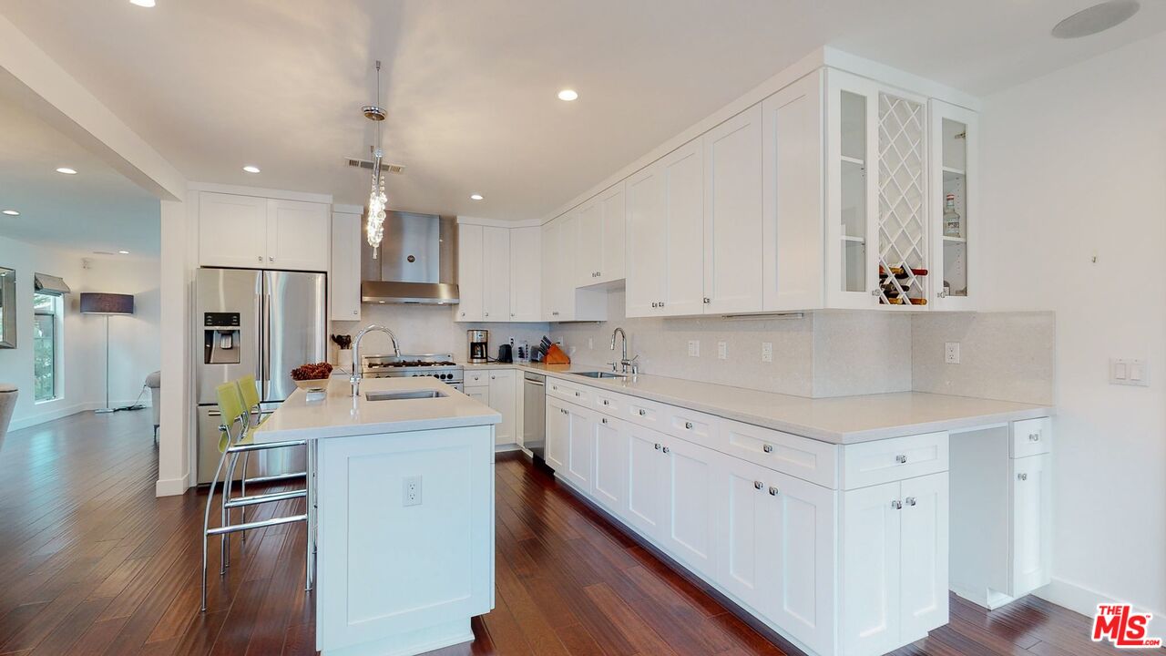 1848 Virginia Road Los Angeles, CA 90019 - Photo 12 of 39 a kitchen with a sink a refrigerator and white cabinets