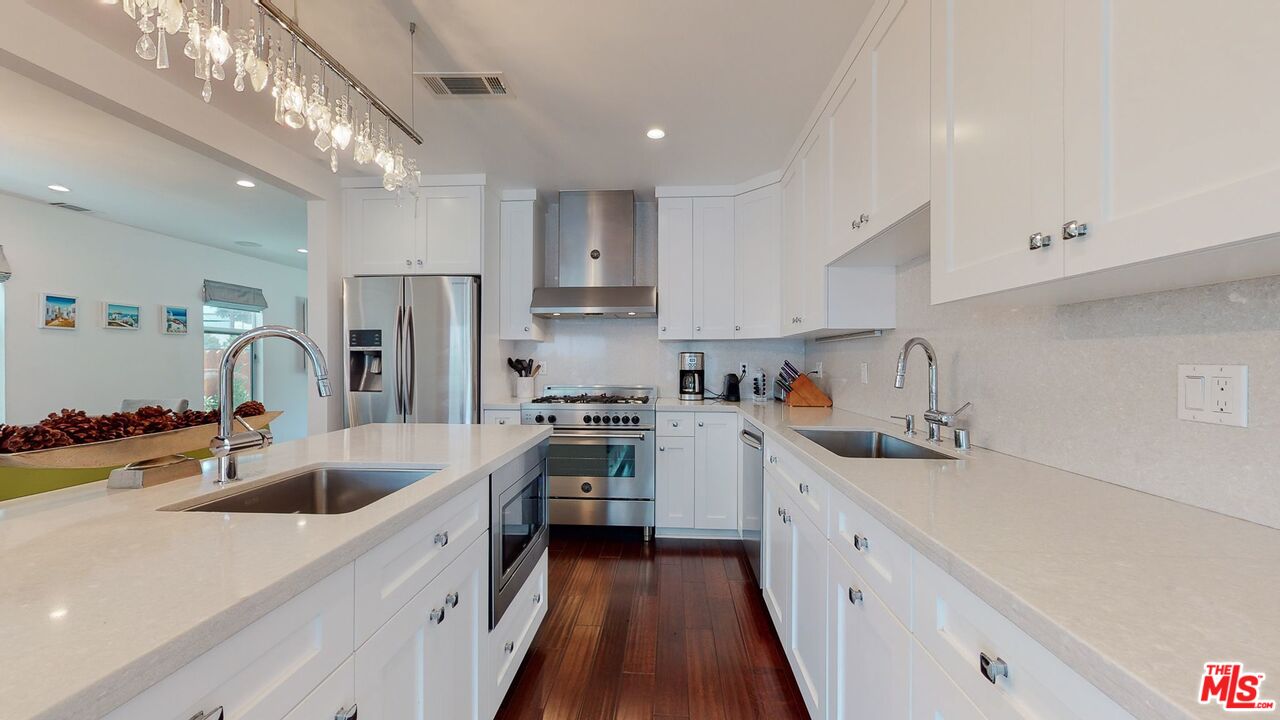 1848 Virginia Road Los Angeles, CA 90019 - Photo 13 of 39 a kitchen with stainless steel appliances a sink stove and refrigerator