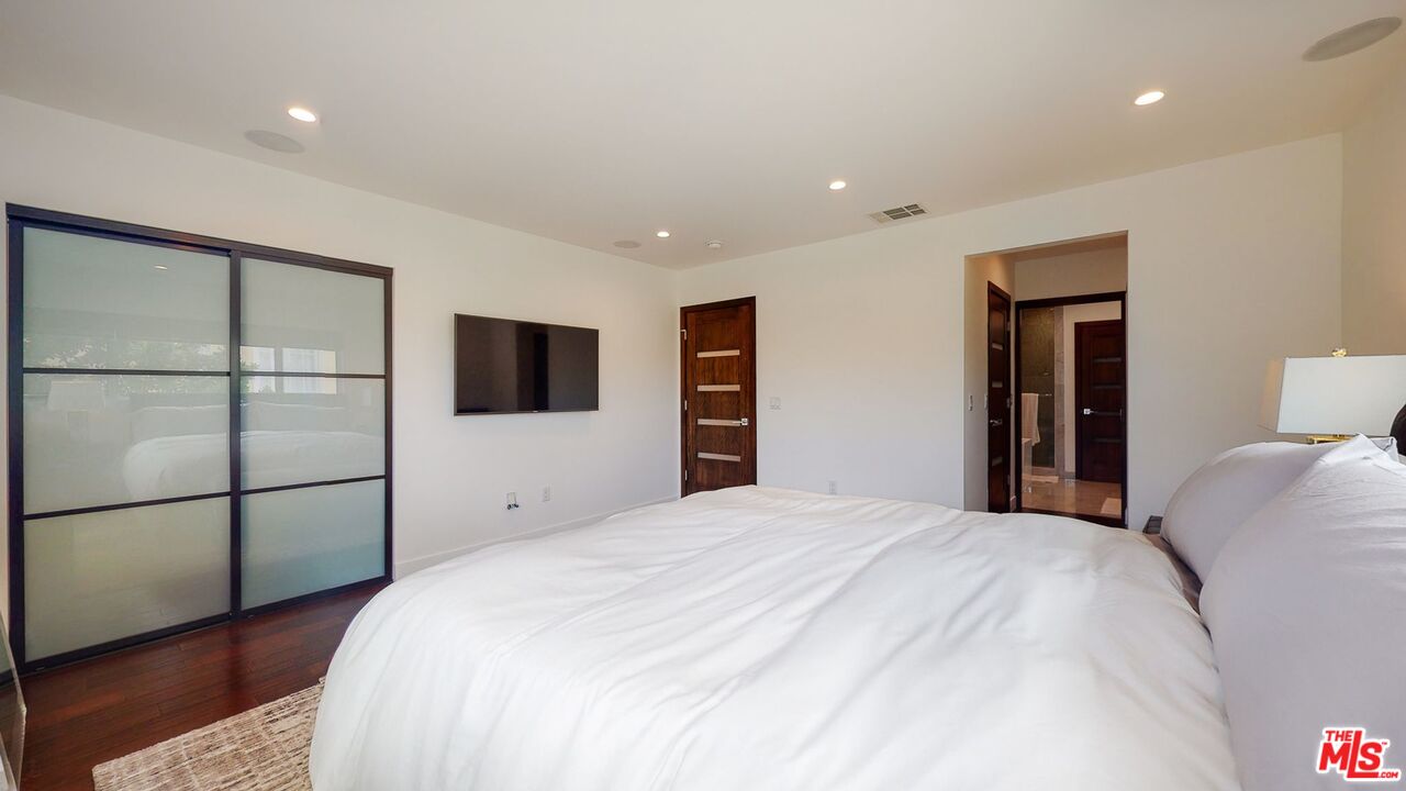 1848 Virginia Road Los Angeles, CA 90019 - Photo 23 of 39 a bedroom with a bed and a flat screen tv
