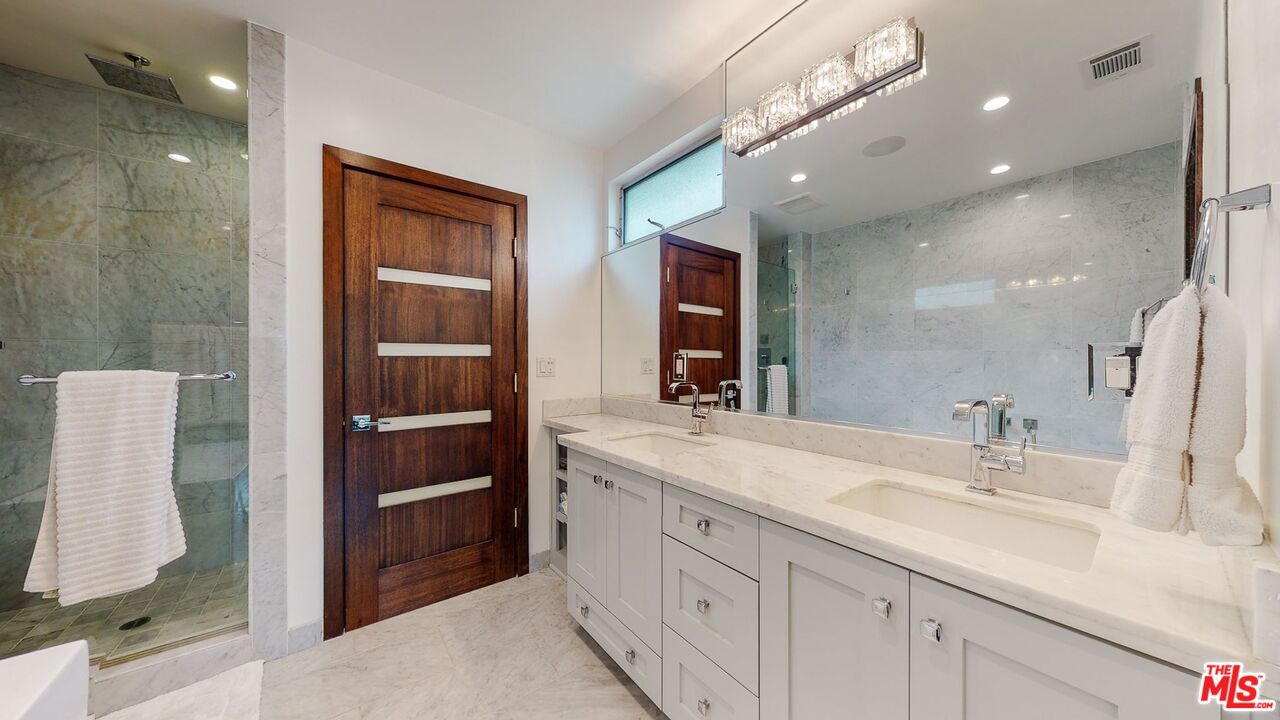 1848 Virginia Road Los Angeles, CA 90019 - Photo 24 of 39 a bathroom with a double vanity sink a mirror and a shower