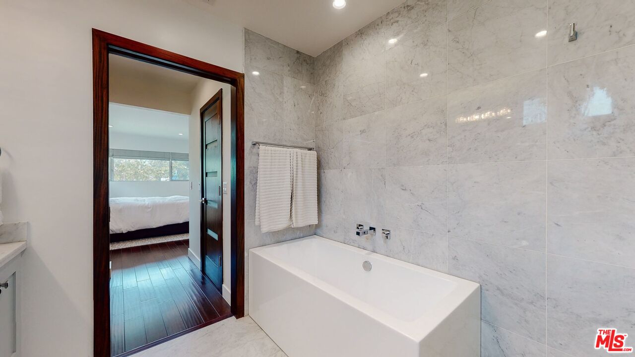 1848 Virginia Road Los Angeles, CA 90019 - Photo 25 of 39 a bathroom with a tub sink vanity and a mirror