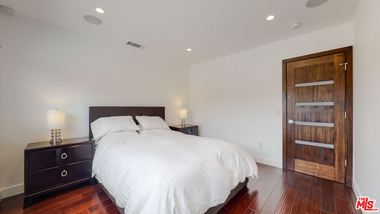 1848 Virginia Road Los Angeles, CA 90019 - Photo 27 of 39 a bedroom with a bed and wooden floor