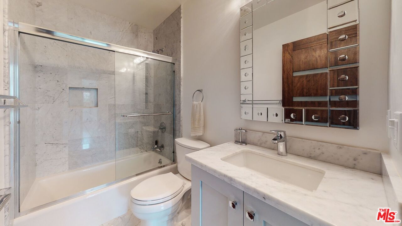 1848 Virginia Road Los Angeles, CA 90019 - Photo 29 of 39 a bathroom with a granite countertop sink a toilet and shower