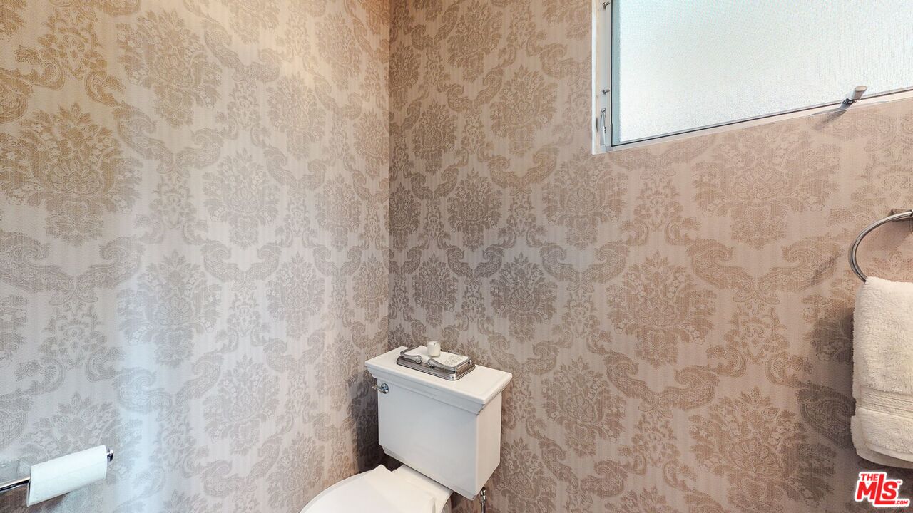 1848 Virginia Road Los Angeles, CA 90019 - Photo 32 of 39 a white toilet sitting next to a white wall