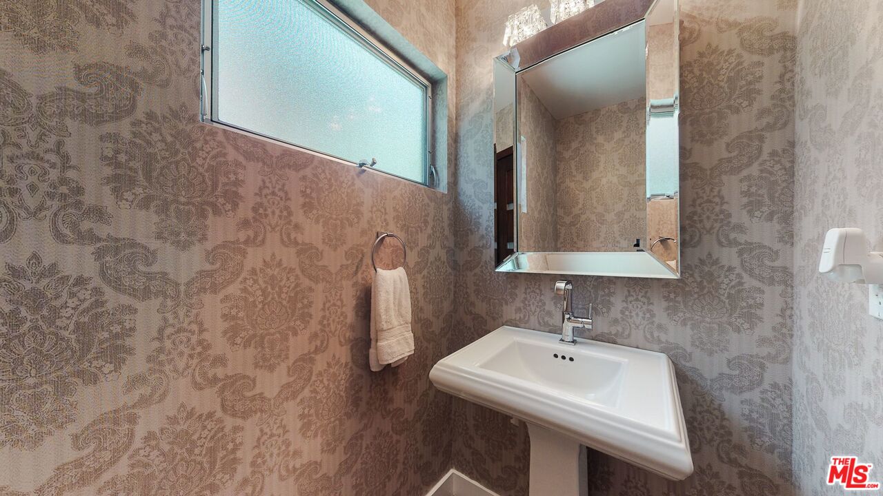 1848 Virginia Road Los Angeles, CA 90019 - Photo 33 of 39 a bathroom with a sink and a mirror