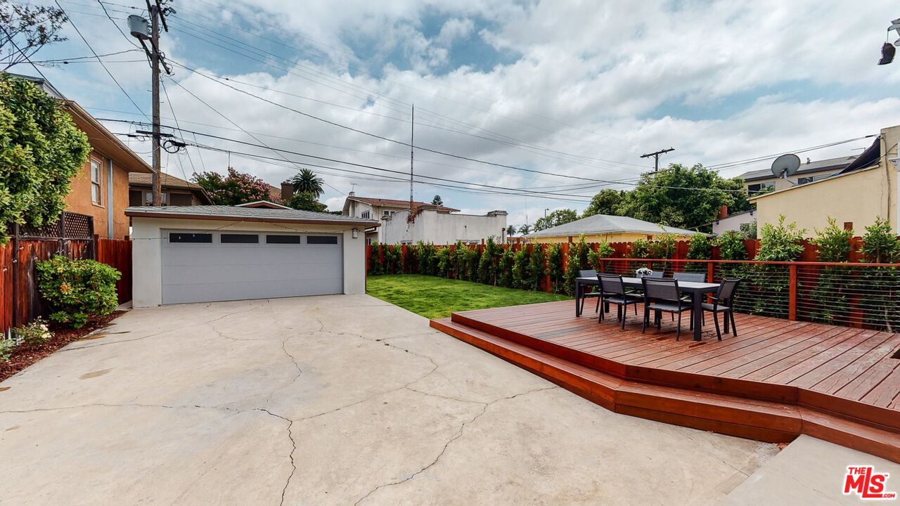 1848 Virginia Road Los Angeles, CA 90019 - Photo 36 of 39 a view of a patio with a table and chairs under an umbrella