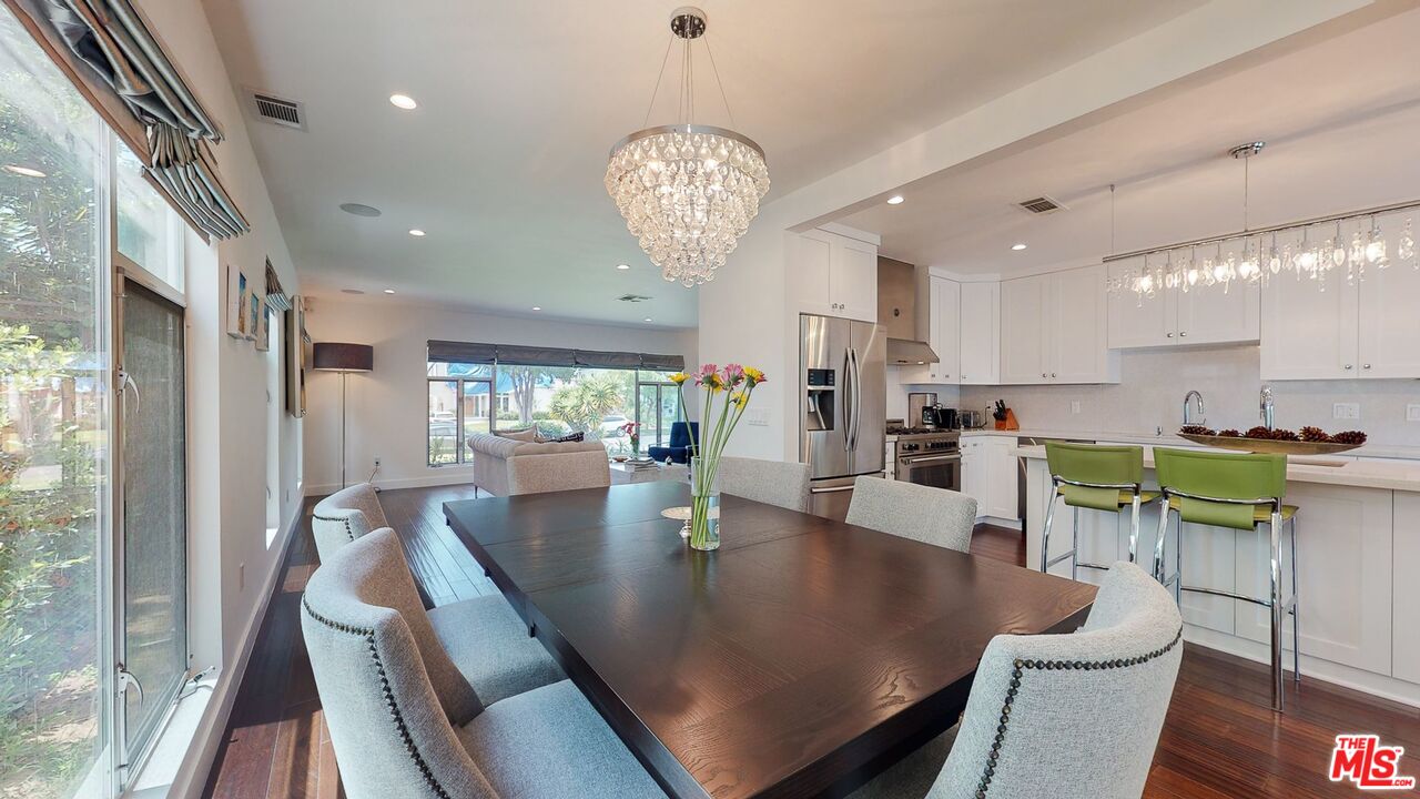 1848 Virginia Road Los Angeles, CA 90019 - Photo 10 of 39 a view of a dining room with furniture a chandelier and wooden floor