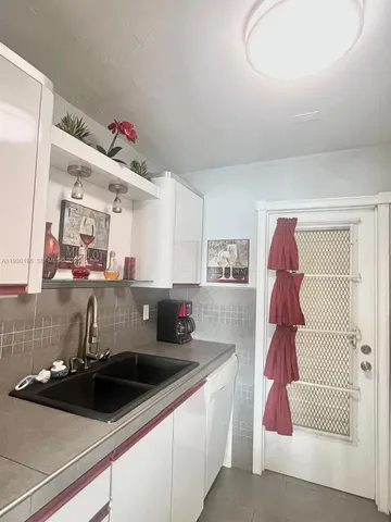 a kitchen with a sink and cabinets