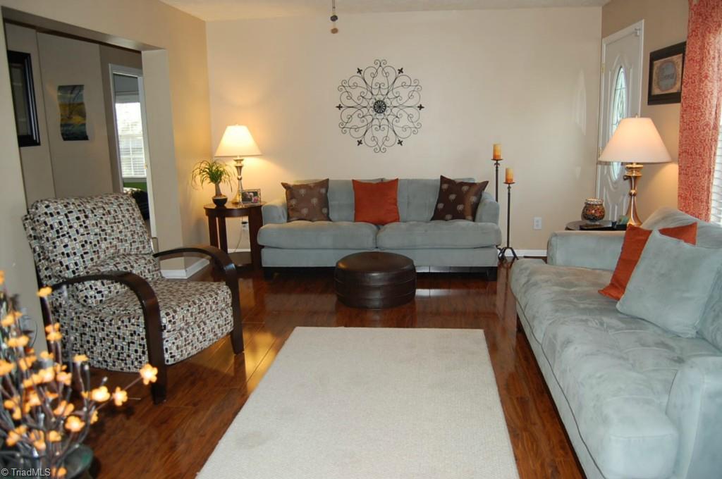 664 Spainhour Road King, NC 27021 - Photo 4 of 12 Living Room has new laminate flooring and beautiful fireplace.