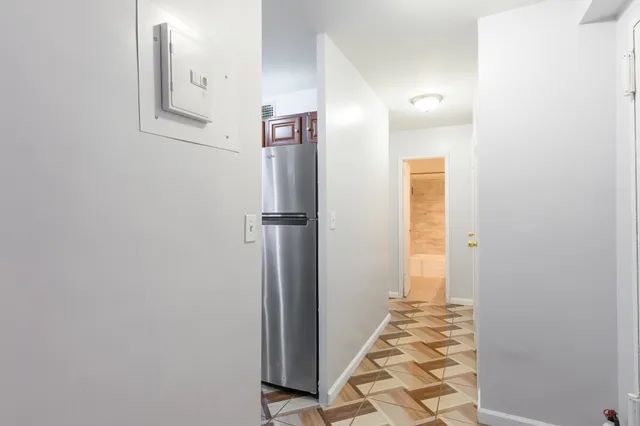 a view of a hallway with wooden floor and entryway