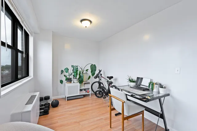 a workspace with furniture and a potted plant