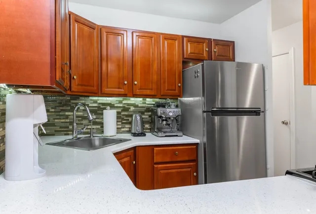 a kitchen with refrigerator and cabinets