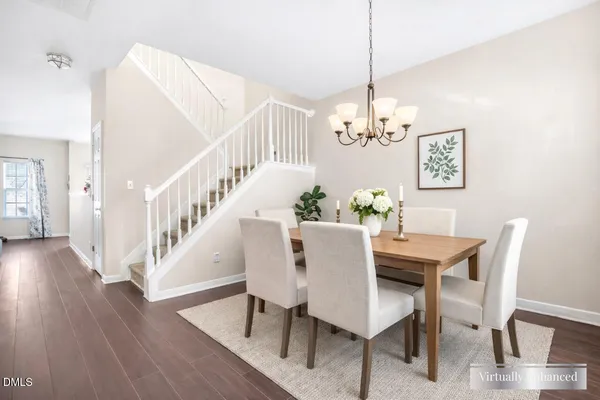 a view of a dining room with furniture wooden floor and chandelier