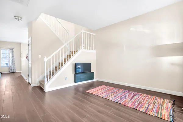 a view of entryway and hall with wooden floor