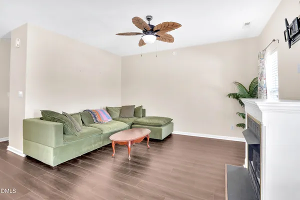 a living room with furniture and a wooden floor