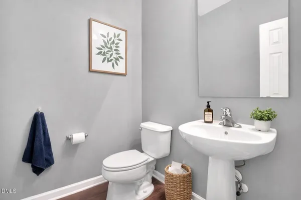 a bathroom with a sink toilet and a mirror