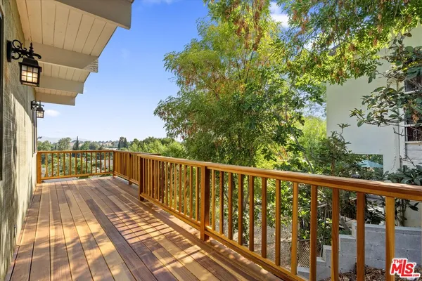 a view of balcony with wooden floor