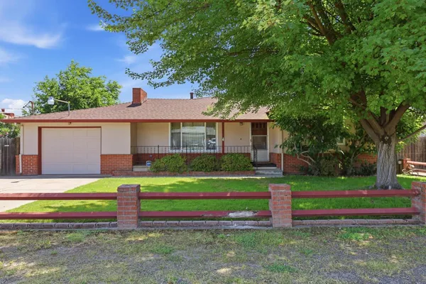 a front view of a house with a yard and porch