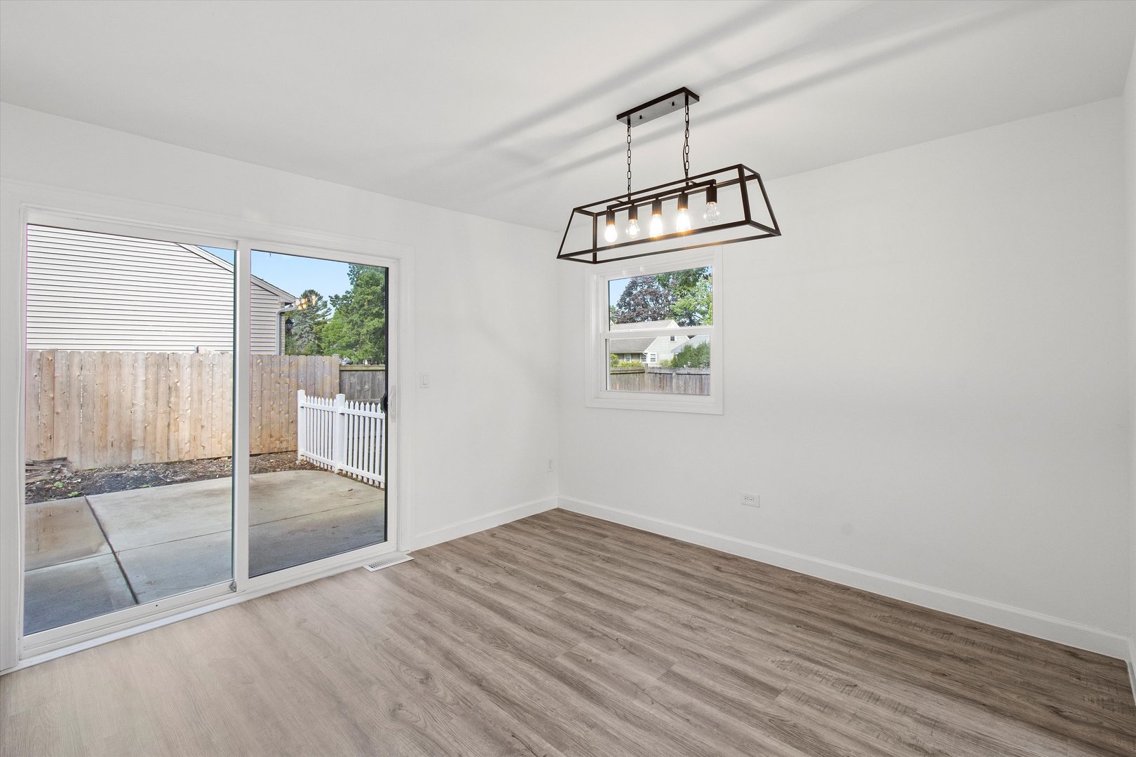 33448 North Greentree Road Grayslake, IL 60030 - Photo 11 of 49 an empty room with wooden floor and windows