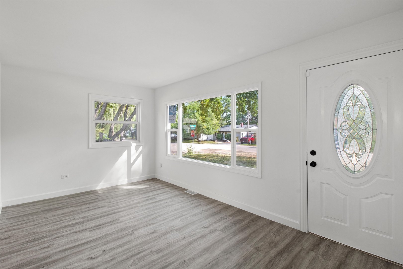 33448 North Greentree Road Grayslake, IL 60030 - Photo 2 of 49 an empty room with wooden floor and windows