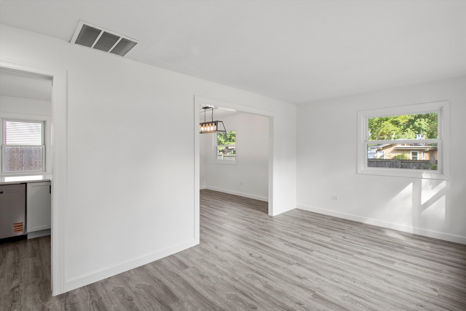 33448 North Greentree Road Grayslake, IL 60030 - Photo 4 of 49 a view of an empty room with window and wooden floor