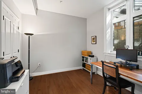 a kitchen with a refrigerator and a stove top oven