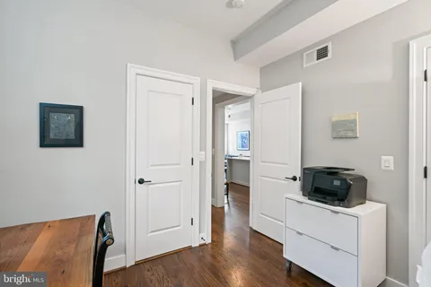a bathroom with a sink a toilet and a large mirror