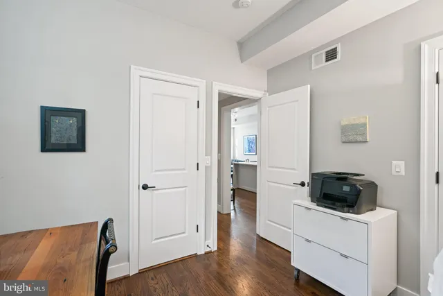 a bathroom with a sink a toilet and a large mirror