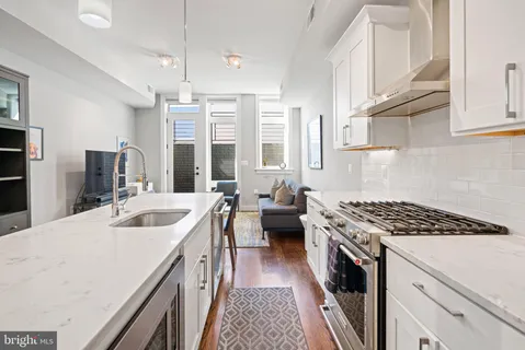 a kitchen with a sink stove and cabinets