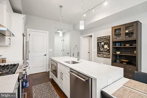 a kitchen with a sink stove and cabinets