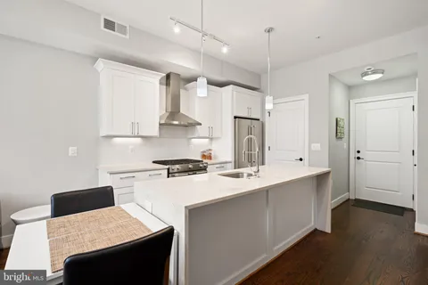 a large kitchen with lots of counter space a sink and appliances