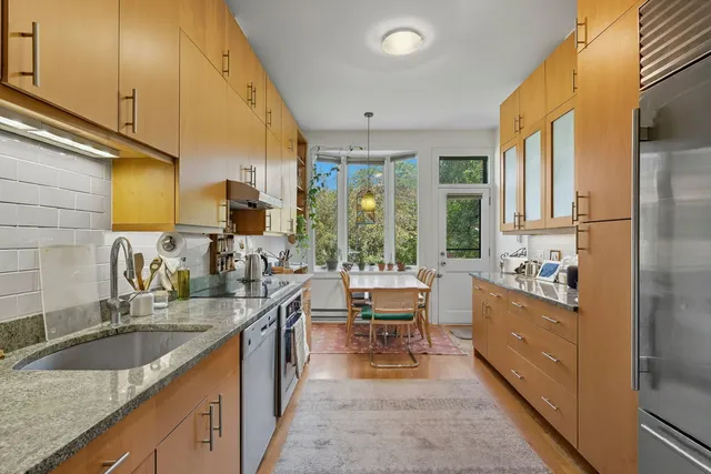 a kitchen with a table chairs stove and refrigerator