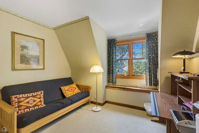 a bedroom with a bed and a chair