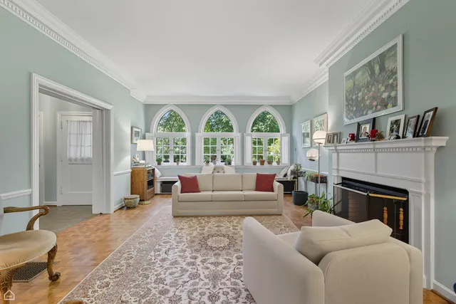 a living room with furniture large window and a fireplace