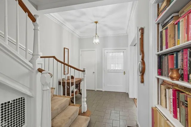 a view of an entryway with wooden floor and stairs