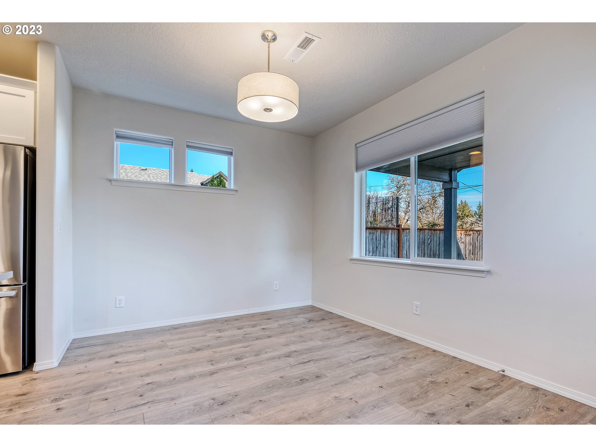 1057 Laura Street Springfield, OR 97477 - Photo 12 of 39 a view of an empty room with wooden floor and a window